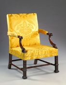 A 19th Century George III Style Carved Mahogany Library Armchair The scrolling arm supports headed