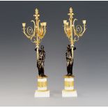 A Pair of French Empire Bronze and Marble Candelabra each with a standing bronze classical maiden