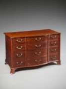 A George III Mahogany Commode in the manner of Thomas Chippendale, the shaped top with a moulded