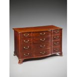 A George III Mahogany Commode in the manner of Thomas Chippendale, the shaped top with a moulded