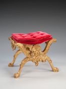 A 19th Century Carved Giltwood Stool in the manner of Henry Williams, of curule form, decorated with