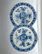 A Pair of Kangxi Blue and White Chargers each with a central medallion surrounded by flowers of