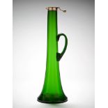 An Emerald Green Glass Decanter in emerald green glass, with star cut base and loop handle,