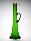 An Emerald Green Glass Decanter in emerald green glass, with star cut base and loop handle,