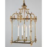 A George III Brass Lantern with four lights, the arched ogival supports above female term figures,