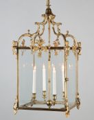 A George III Brass Lantern with four lights, the arched ogival supports above female term figures,