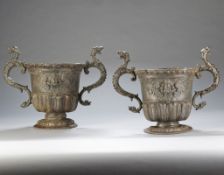 A Pair of 18th Century Lead Urns the urn shaped bodies with cabochon moulded rims each above a