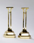 A Pair of Polished Brass William Tonks Door Stops each with a stepped half hexagon base, stamped