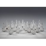 A Set of Eighteen 19th Century Cut Glass Decanters each with a broad band of cut diamonds below