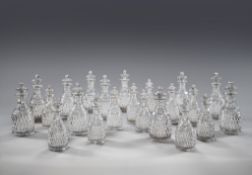 A Set of Eighteen 19th Century Cut Glass Decanters each with a broad band of cut diamonds below