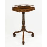 A Carved Mahogany Octagonal Tripod Table the tilting top with a turned spindle gallery inlaid with