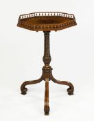 A Carved Mahogany Octagonal Tripod Table the tilting top with a turned spindle gallery inlaid with