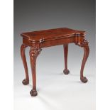 A George II Style Mahogany Card Table the shaped top, opening with a concertina action to reveal a