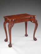A George II Style Mahogany Card Table the shaped top, opening with a concertina action to reveal a