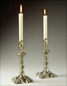 A Pair of 18th Chinese Paktong Candlesticks with fluted column stems surmounted by foliate
