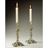 A Pair of 18th Chinese Paktong Candlesticks with fluted column stems surmounted by foliate