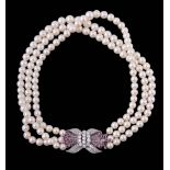 A three row cultured pearl, diamond and ruby necklace A three row cultured pearl, diamond and ruby