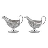 A pair of George III Irish silver shaped oval pedestal sauce boats by... A pair of George III