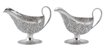 A pair of George III Irish silver shaped oval pedestal sauce boats by... A pair of George III