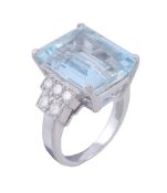 An aquamarine and diamond ring, the central rectangular cut aquamarine claw... An aquamarine and