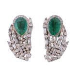 A pair of emerald and diamond ear clips, the pear cut emerald within a... A pair of emerald and