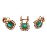 A pair of emerald and diamond earrings, the central step cut emerald with... A pair of emerald and