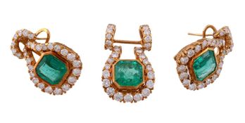 A pair of emerald and diamond earrings, the central step cut emerald with... A pair of emerald and