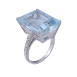 An aquamarine and diamond ring, the rectangular step cut aquamarine in a... An aquamarine and