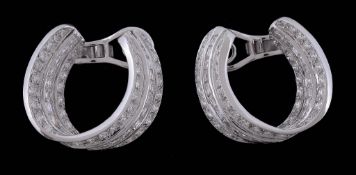 A pair of diamond hoop earrings, the twisted hoops set with brilliant cut... A pair of diamond