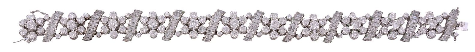 A diamond bracelet, composed of flower head clusters set with brilliant cut... A diamond bracelet,