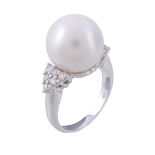 A South Sea cultured pearl and diamond ring A South Sea cultured pearl and diamond ring, the central
