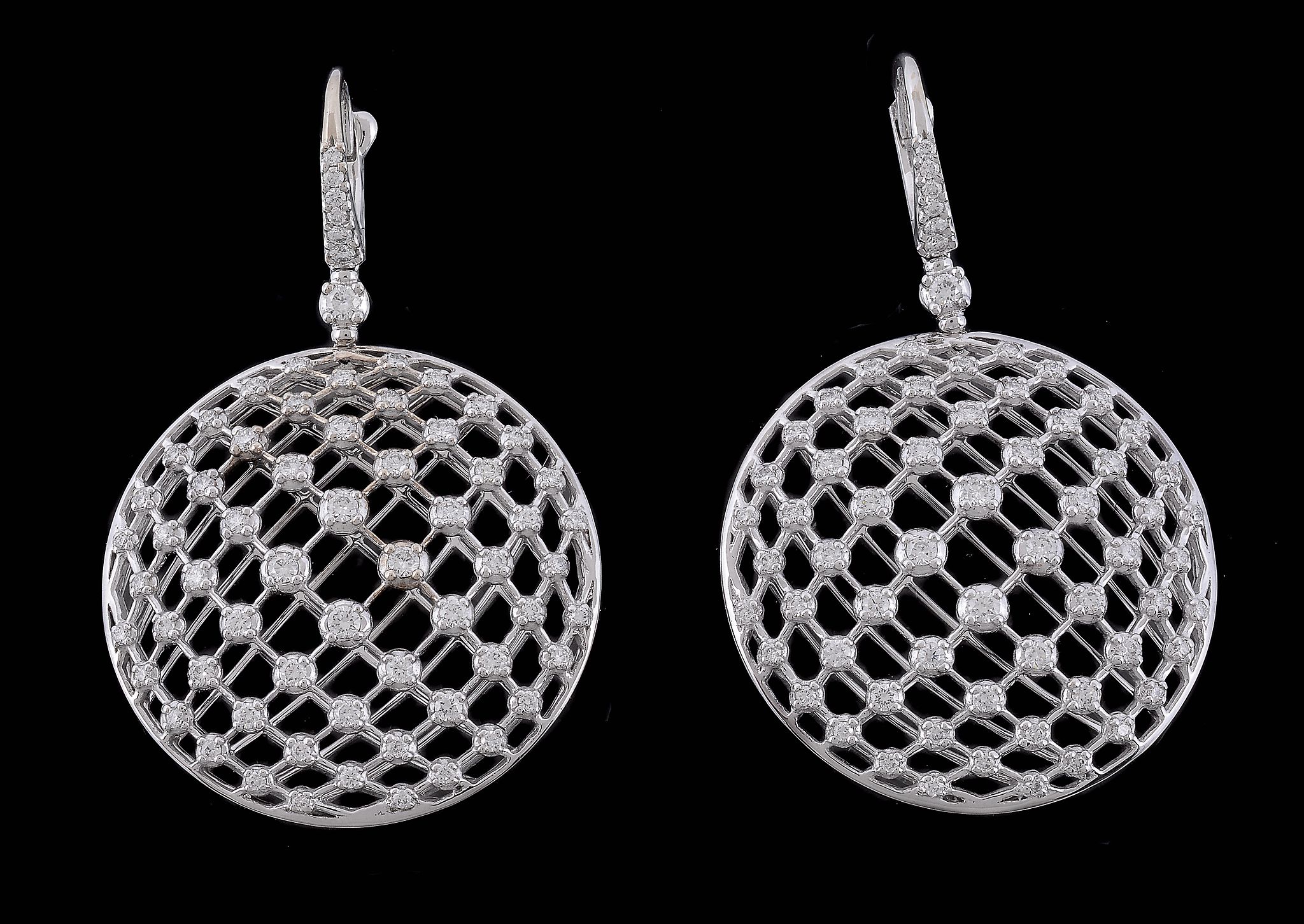 A pair of diamond earrings, the circular lattice panels set with brilliant... A pair of diamond