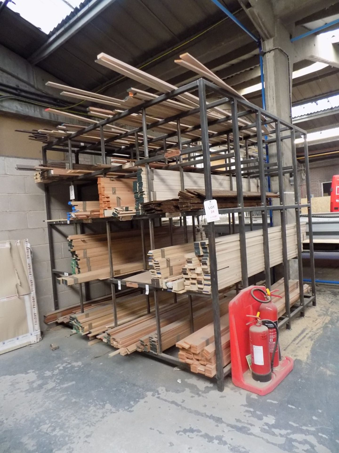 Welded steel rack and contents of assorted planed hardwood, approx. 400 pieces, each 2460mm long