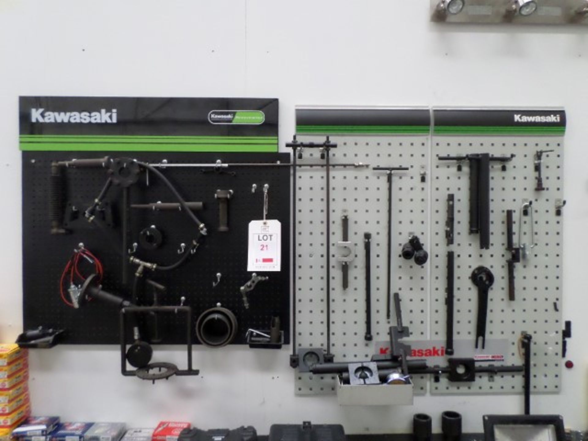 2 Kawasaki wall boards with a quantity of assorted special tools