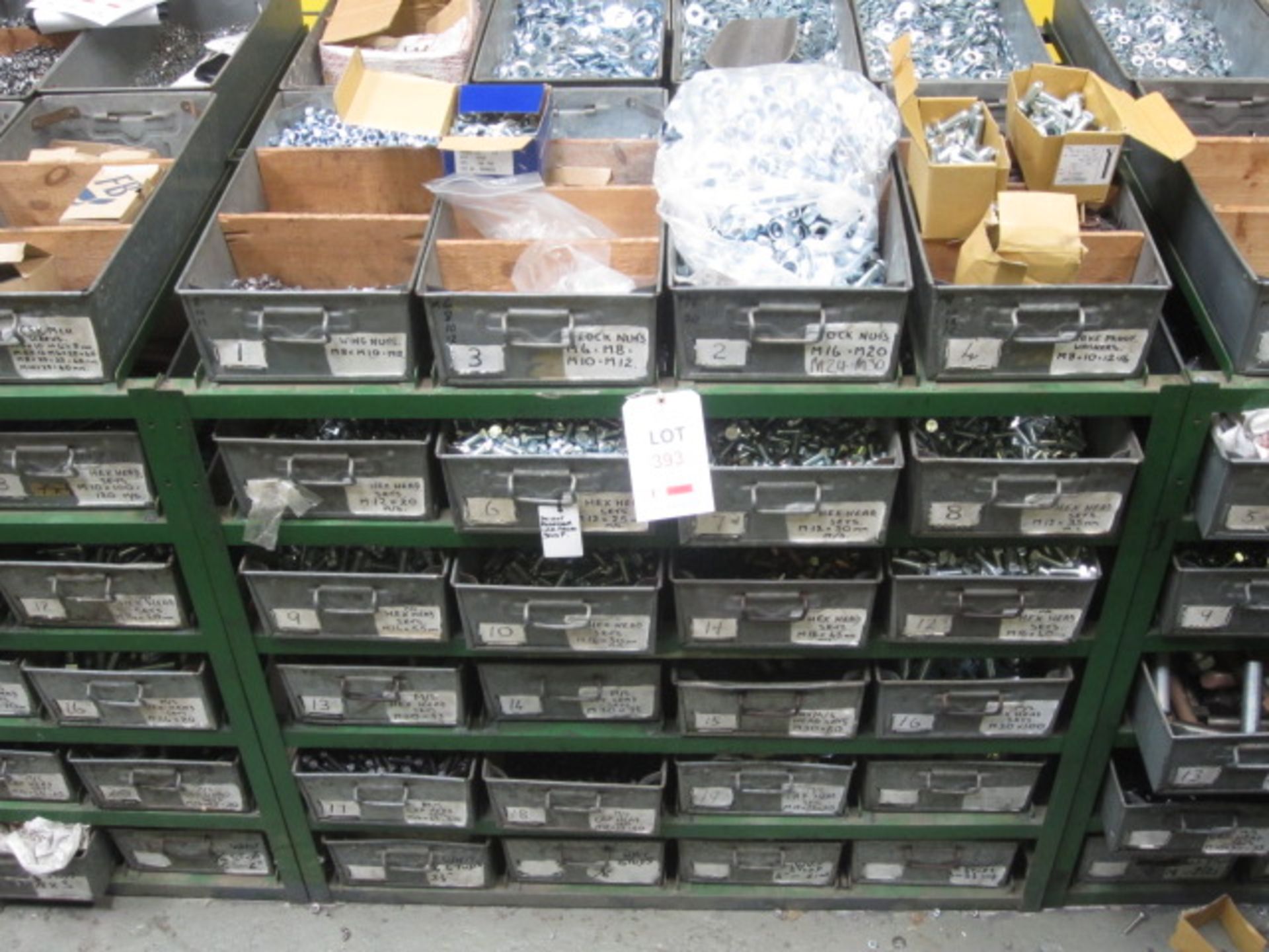 Steel frame rack and metal tote bins with contents including: wing nuts, nylon unit nuts, sake proof