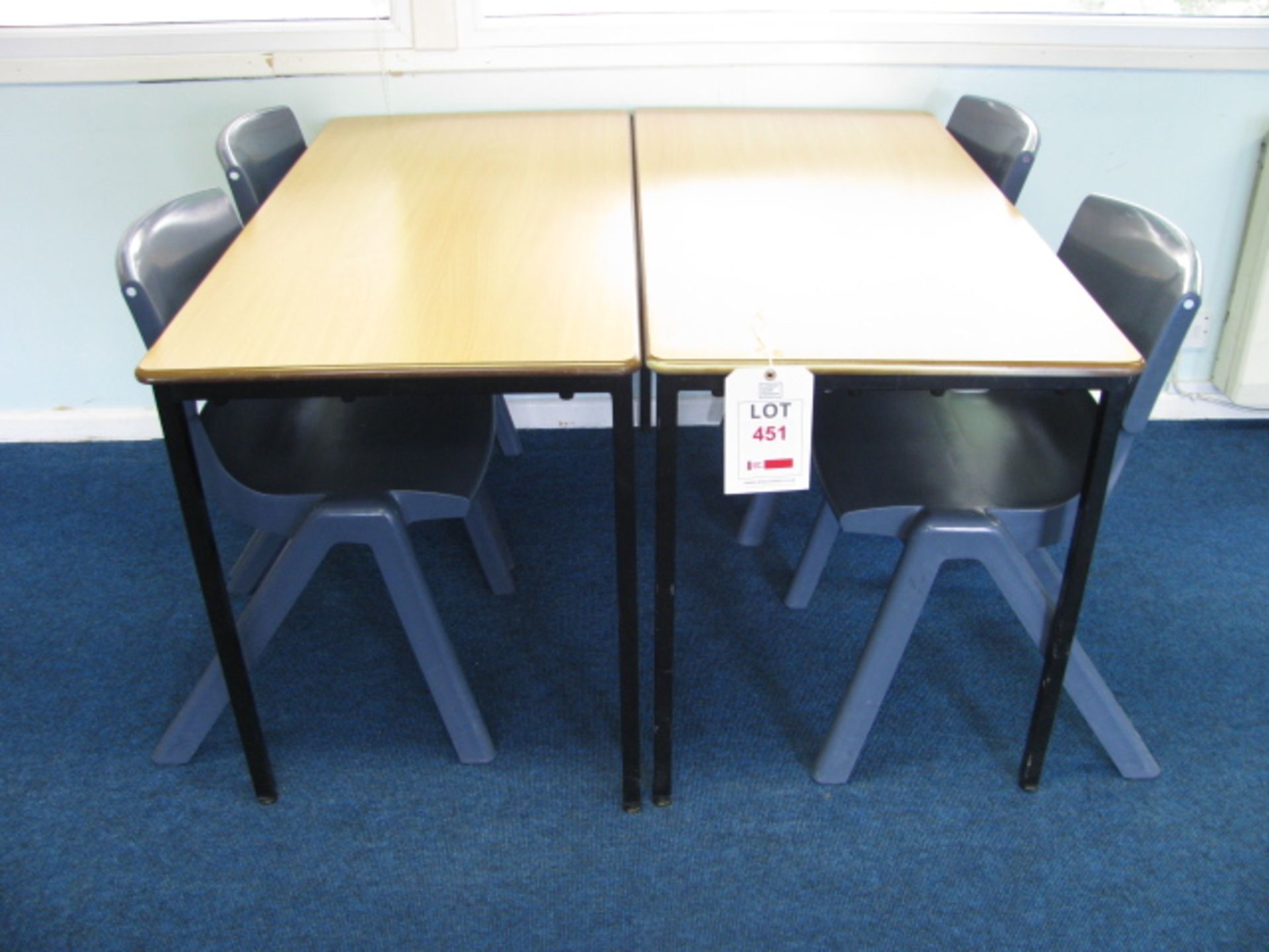 Two light oak veneered student desks with four Sebel Postura plastic chairs