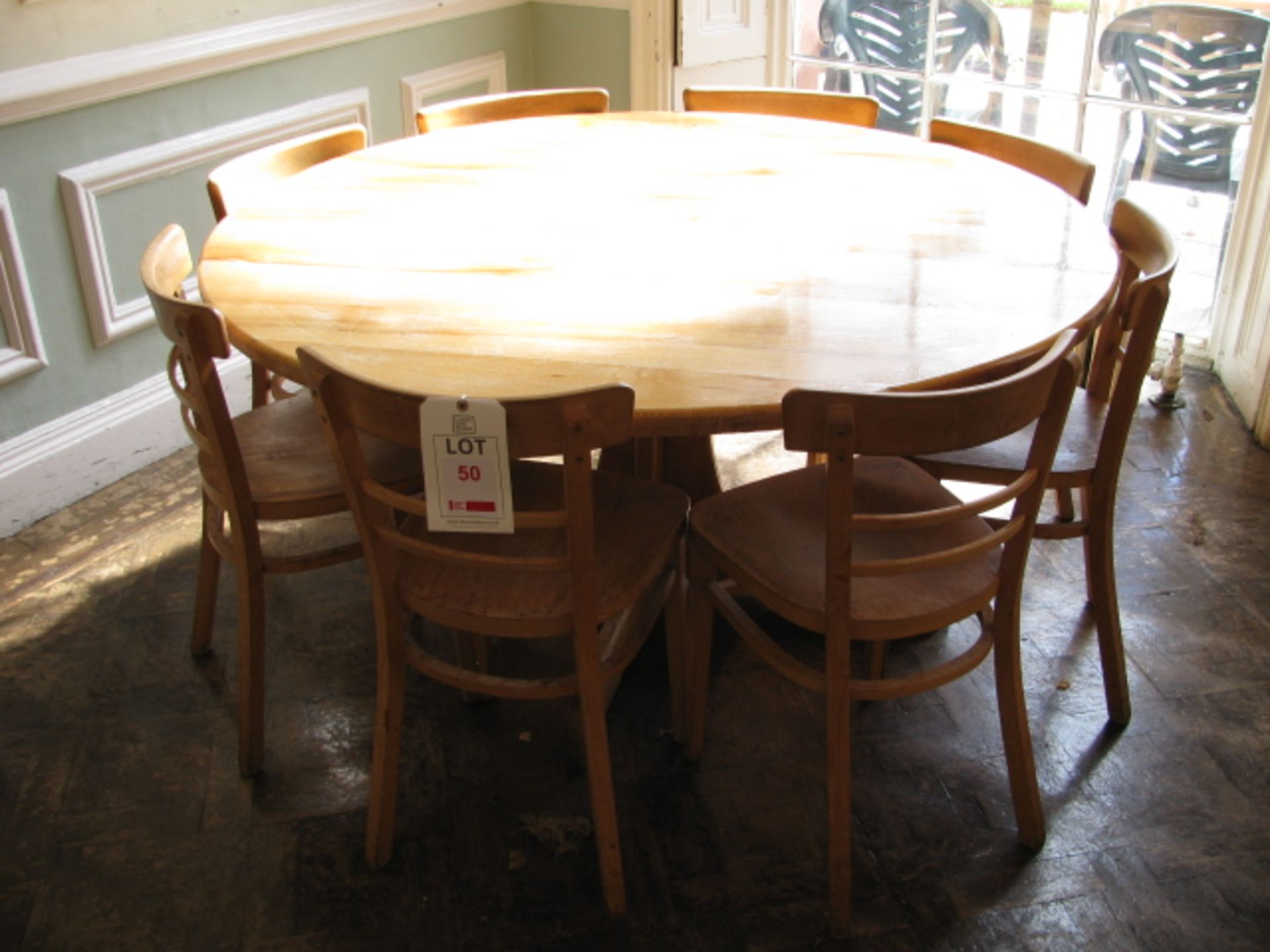 Round pine table with eight contrasting chairs