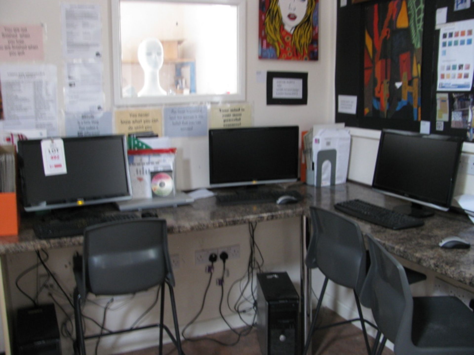 Three Dell Optiplex personal computers each with widescreen monitor, keyboard and mouse