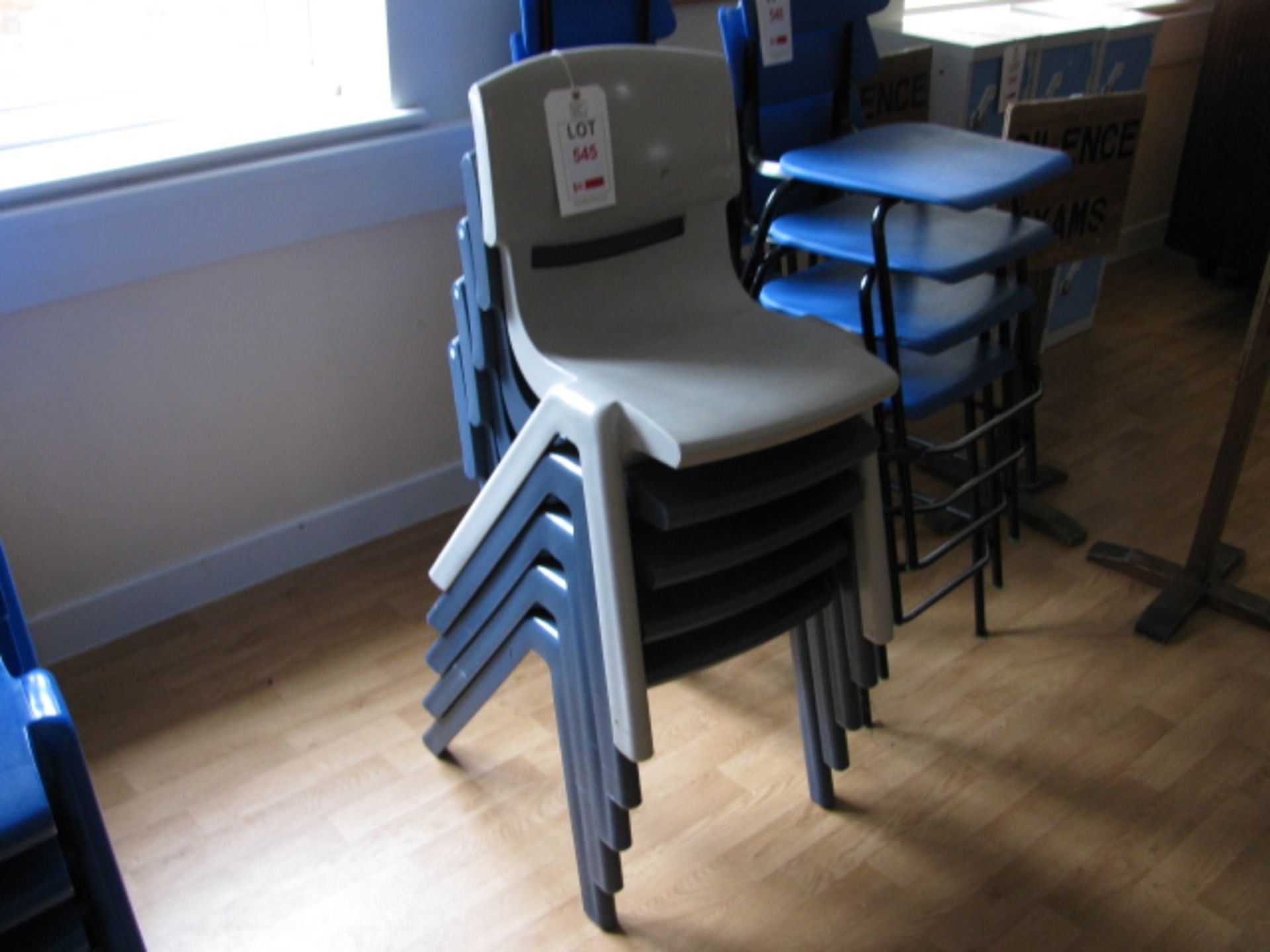 Five Sebel Postura (four dark blue / one grey) plastic chairs