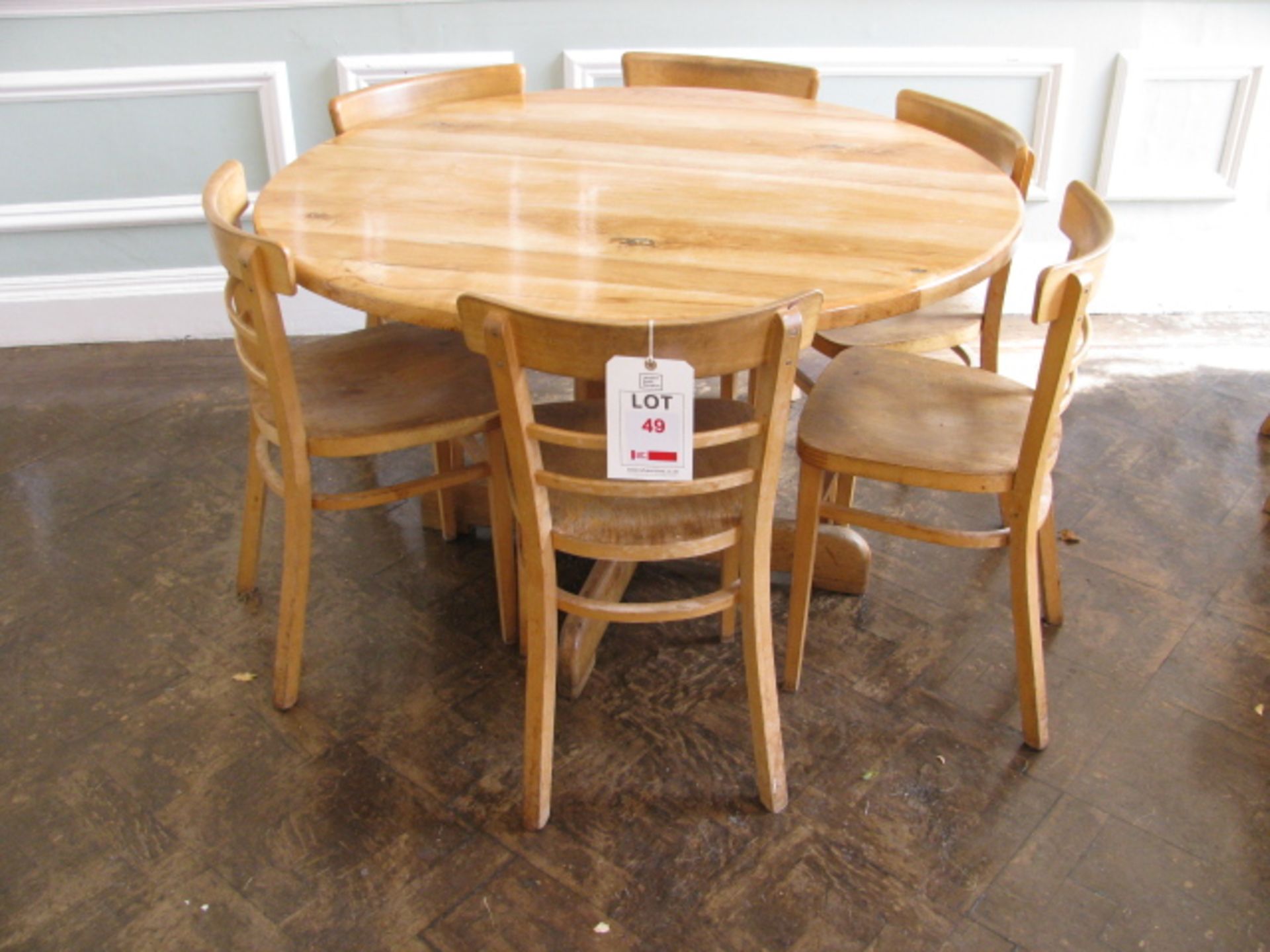 Round pine table with six contrasting chairs