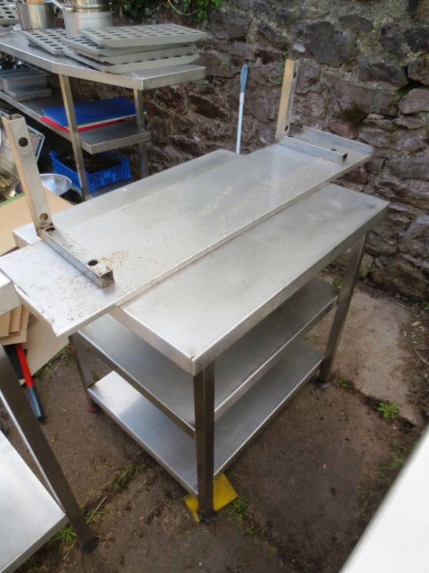 Stainless Steel table with twin under counter shelves, approximate dimensions: 600 x 750mm and