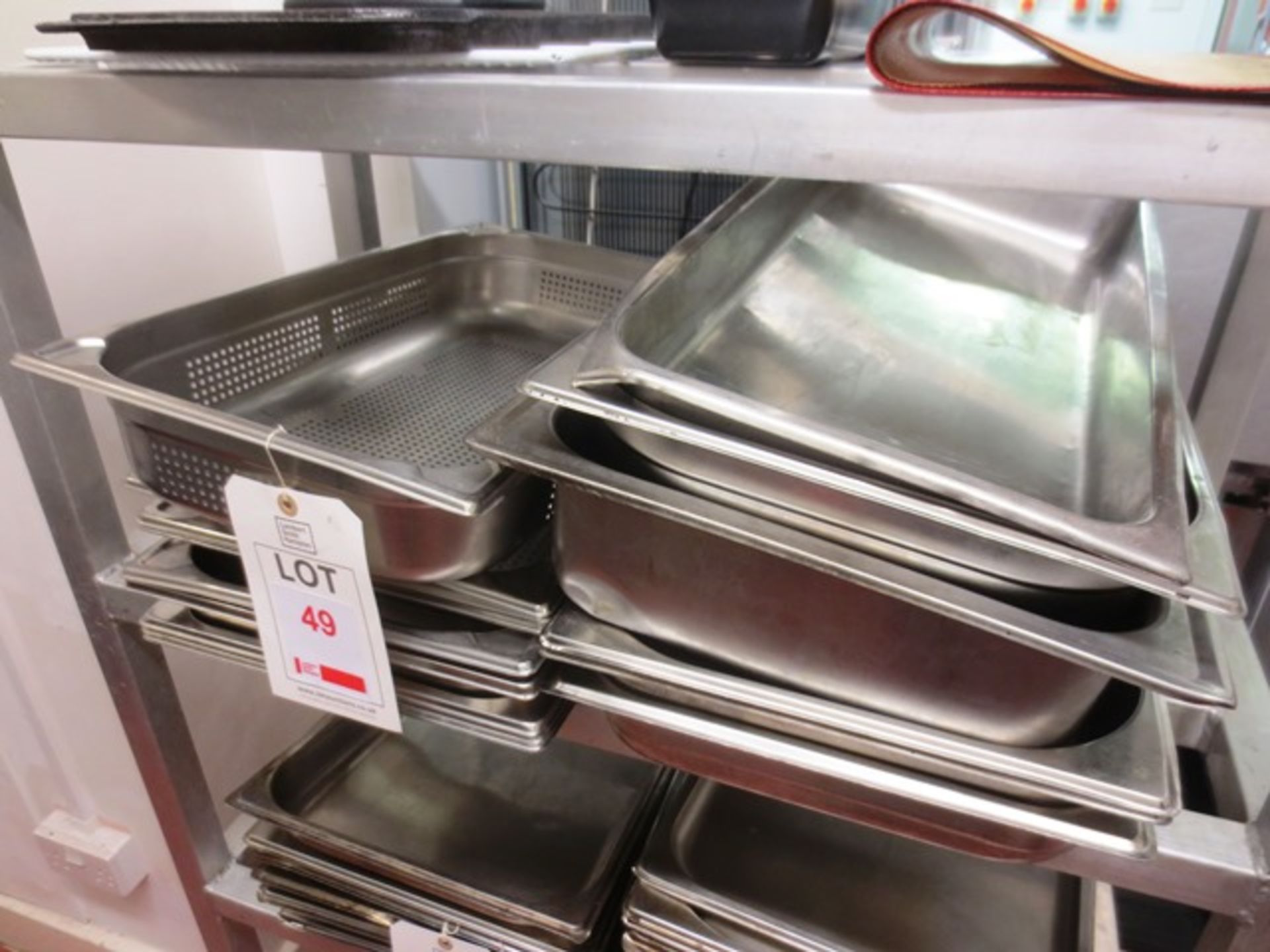 Quantity of stainless steel serving trays (approx 19 in total)