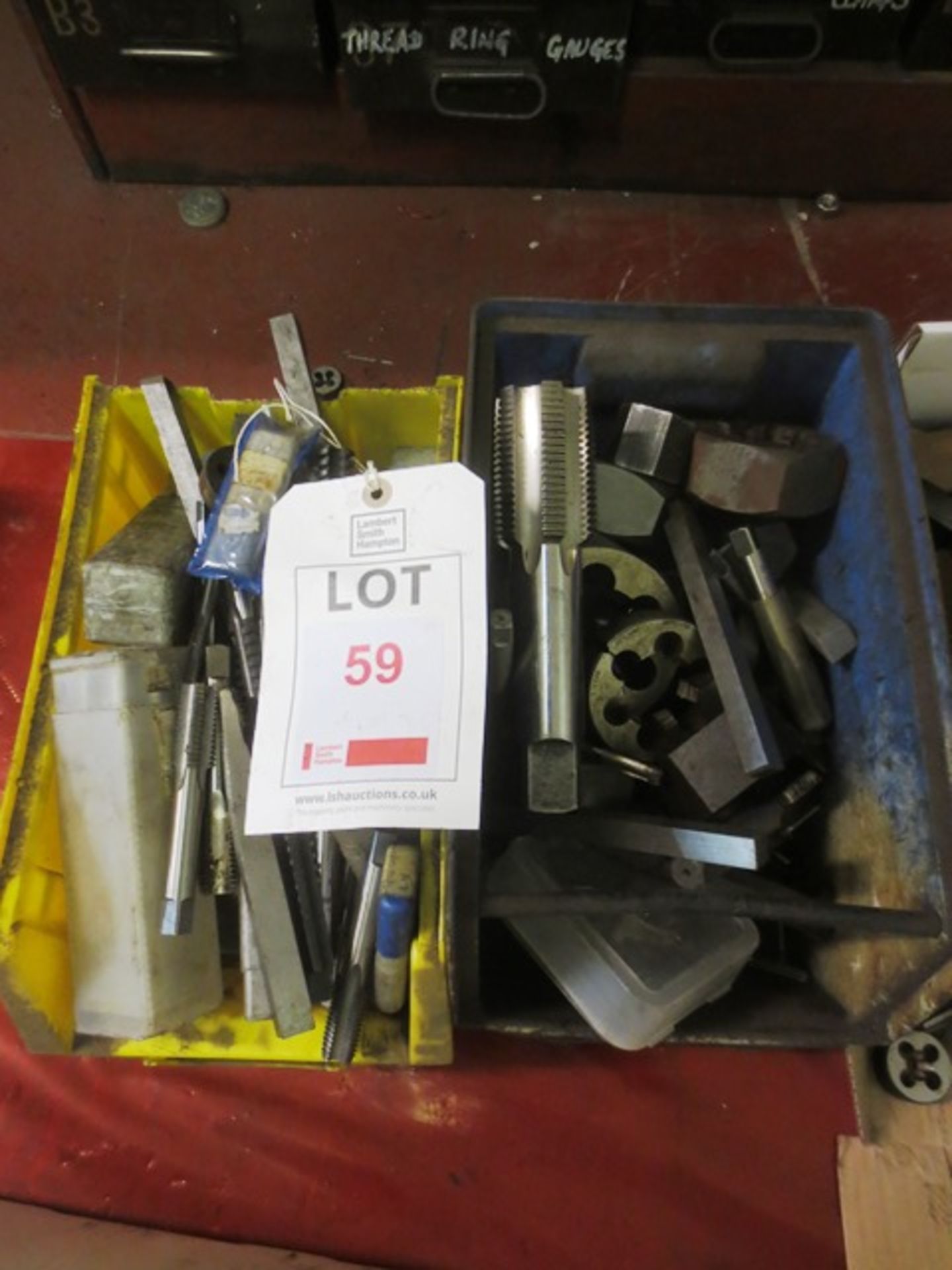 A box of large HSS hand taps and dies (imperial) circa 11/4" to 21/4" (Please note: Steel tote