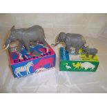 A pair of boxed Britain's plastic elephants, 1310 and 1311. The large elephant has an ear