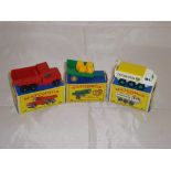 A group of three Matchbox vehicles to include a number 48 dumper truck, a number 61 trailer and a