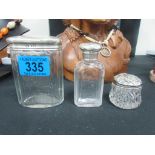 3 silver topped bottles