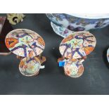 Pair of Staffordshire cups and saucers on wood stands