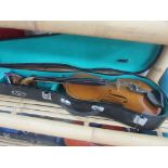 Cased violin with sheet music