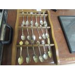 Commemorative spoons on wooden stand