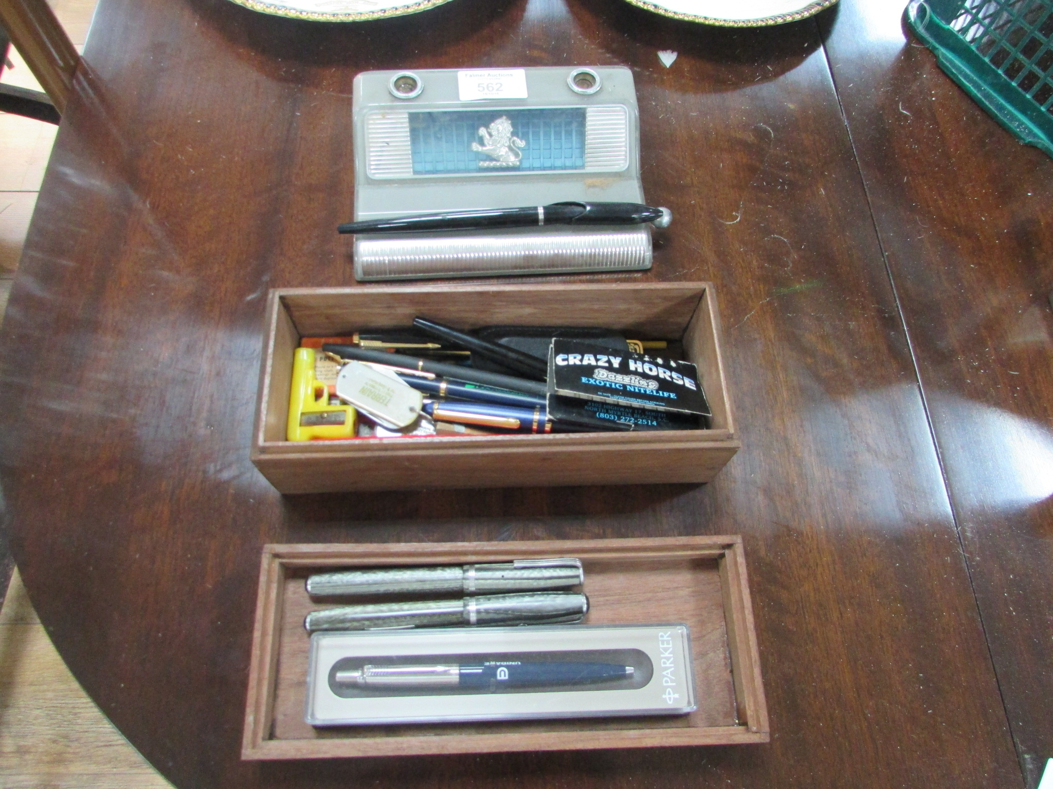 Box of pens and desk stand